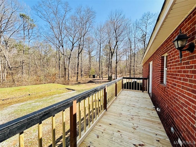 wooden terrace featuring a lawn