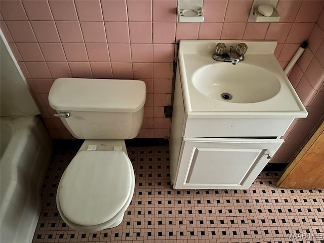 bathroom featuring tile walls, tile patterned flooring, vanity, and toilet