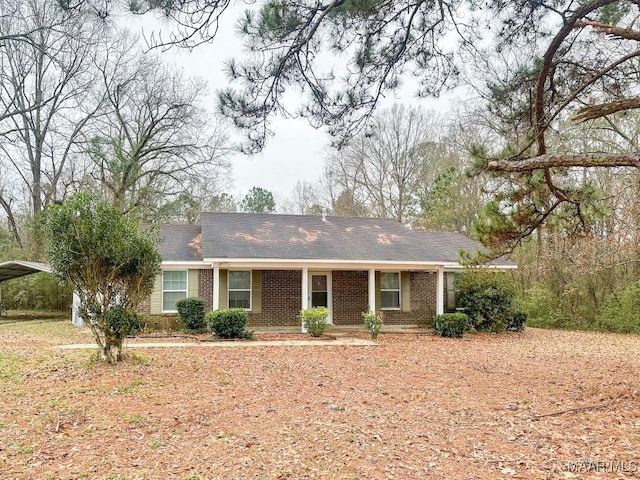 ranch-style house featuring brick siding