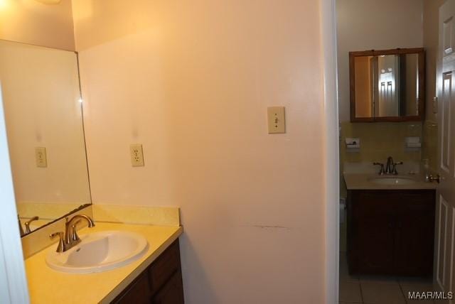 bathroom with tile patterned flooring and vanity