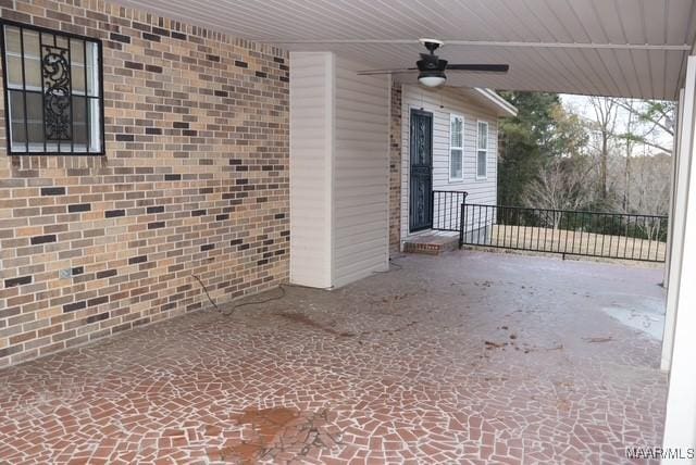 view of patio with fence and a ceiling fan