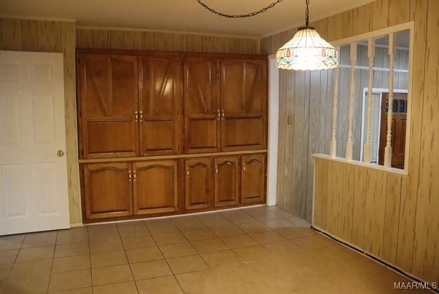 interior space featuring tile patterned flooring and wooden walls