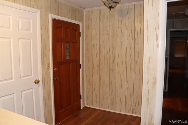 interior space featuring dark wood-style floors and wood walls