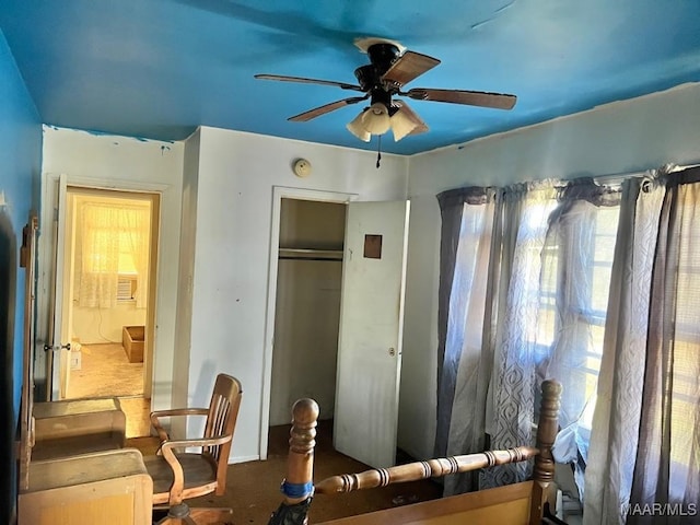 interior space featuring ceiling fan and a closet