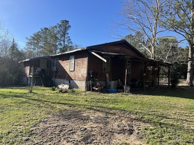 view of side of home with a lawn