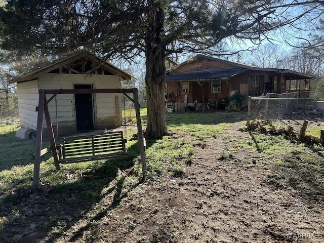 view of yard featuring a shed, fence, and an outdoor structure