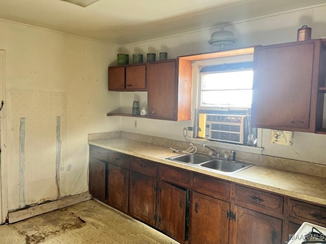 kitchen with cooling unit, light countertops, and a sink