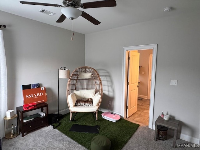 sitting room with carpet, visible vents, and baseboards