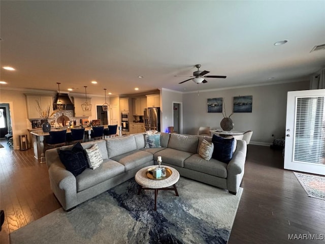 living area featuring dark wood-type flooring, recessed lighting, visible vents, and crown molding