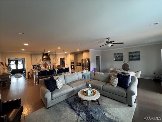 living area featuring baseboards, recessed lighting, wood finished floors, and crown molding