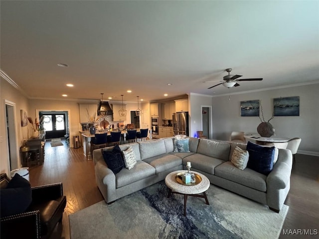 living room featuring ceiling fan, ornamental molding, wood finished floors, and recessed lighting