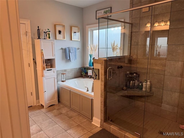 bathroom featuring tile patterned flooring, a shower stall, and a bath