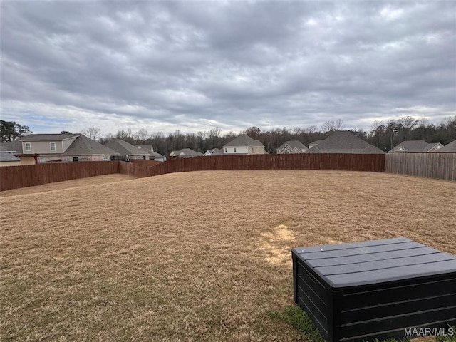 view of yard with a fenced backyard and a residential view