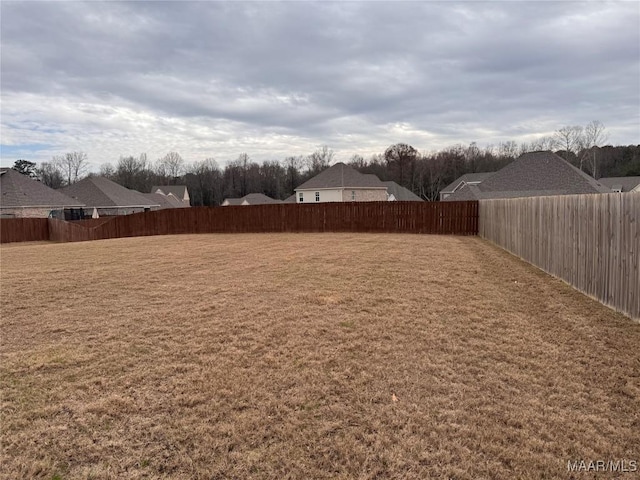 view of yard with a residential view and a fenced backyard