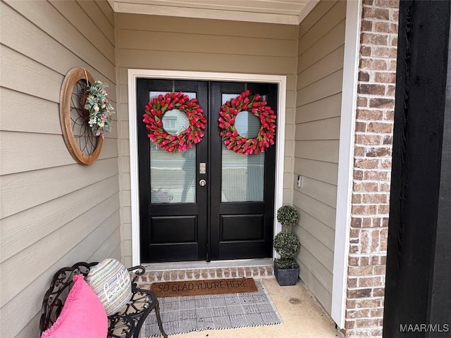 entrance to property with french doors and brick siding