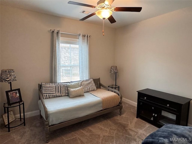 carpeted bedroom featuring visible vents, baseboards, and a ceiling fan