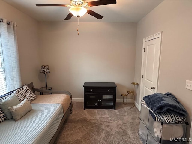 bedroom featuring baseboards, ceiling fan, and light colored carpet