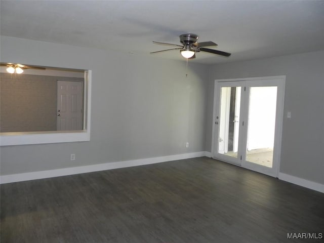 empty room with a ceiling fan, baseboards, and dark wood-style flooring