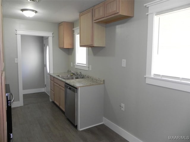 kitchen with light countertops, dishwasher, a sink, and baseboards