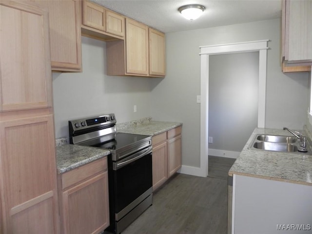 kitchen featuring light brown cabinetry, a sink, light countertops, and stainless steel electric stove