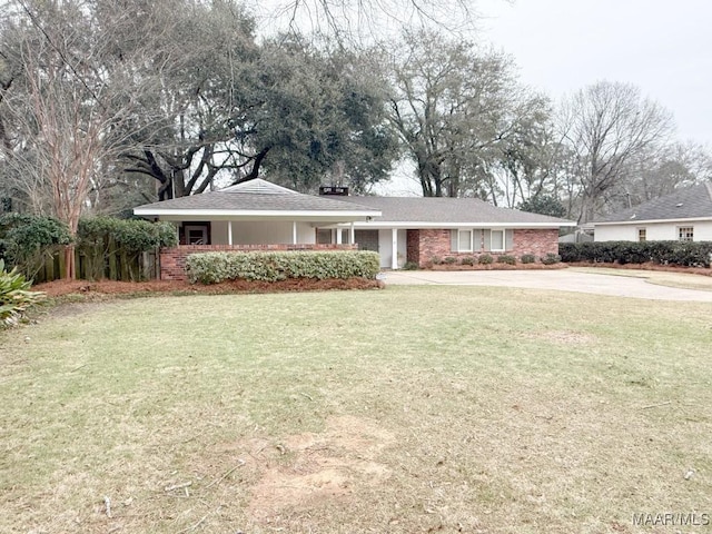 ranch-style house with a front lawn and brick siding