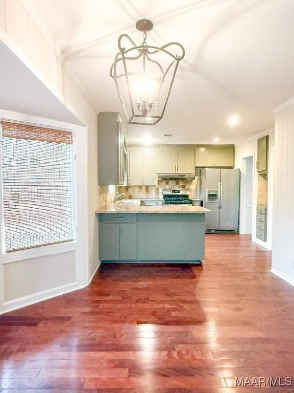 kitchen featuring a peninsula, fridge with ice dispenser, a chandelier, and dark wood finished floors