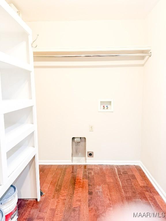 clothes washing area featuring hookup for a washing machine, hookup for an electric dryer, wood finished floors, laundry area, and baseboards