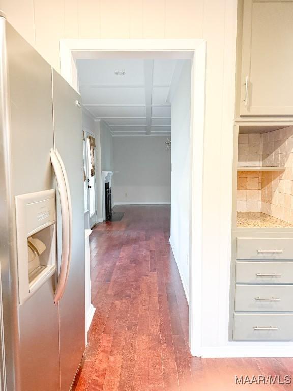 hallway with wood finished floors and baseboards