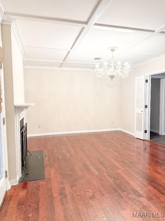 unfurnished living room featuring a chandelier, a fireplace, wood finished floors, and baseboards