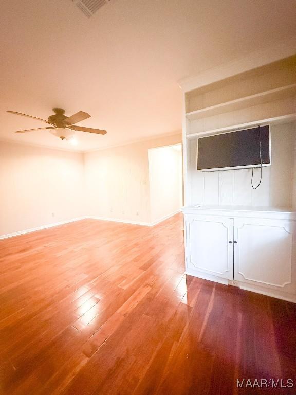 unfurnished living room featuring a ceiling fan, baseboards, visible vents, and light wood finished floors