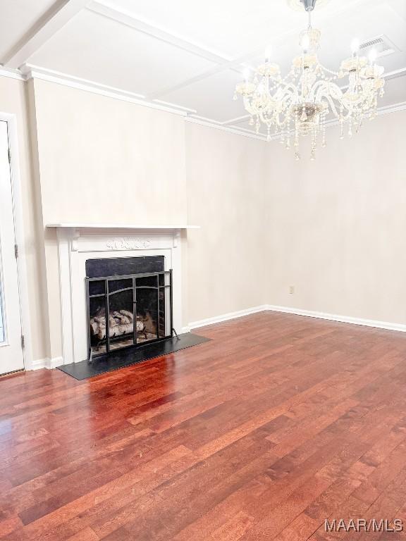 unfurnished living room with baseboards, a fireplace, ornamental molding, and wood finished floors