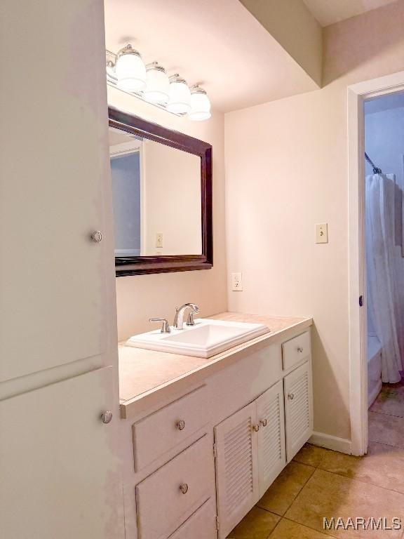 full bathroom featuring baseboards, vanity, and tile patterned floors