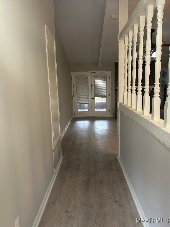 hall featuring baseboards, beam ceiling, stairway, and wood finished floors