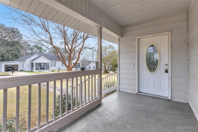 view of exterior entry featuring a porch and a residential view