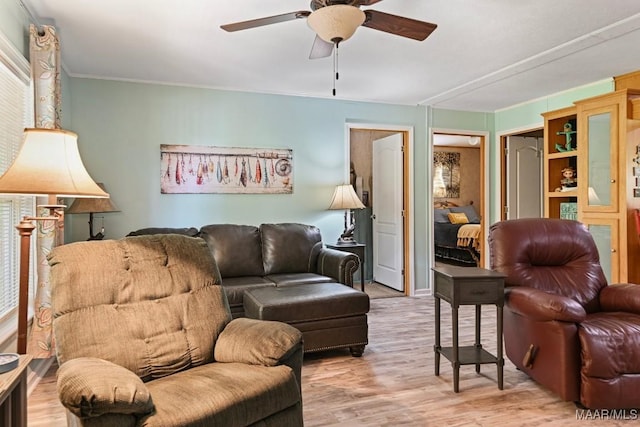 living room with ceiling fan and light wood-type flooring