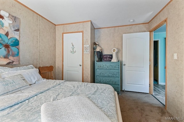 bedroom with ornamental molding and carpet flooring