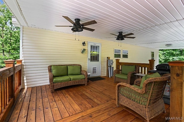 deck featuring ceiling fan and an outdoor living space