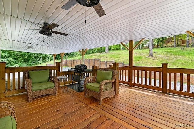 wooden deck with ceiling fan, a yard, and fence