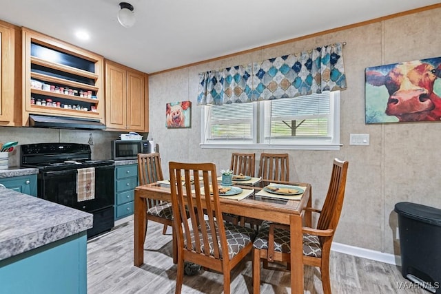 kitchen with under cabinet range hood, light wood-style floors, black electric range, light brown cabinetry, and stainless steel microwave