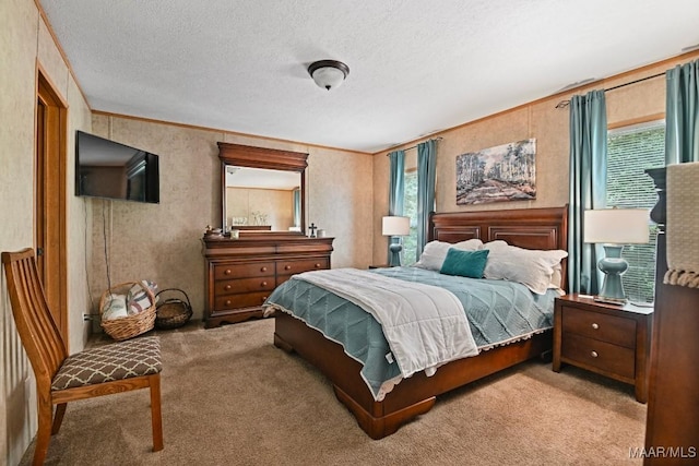 bedroom with light carpet, ornamental molding, and a textured ceiling