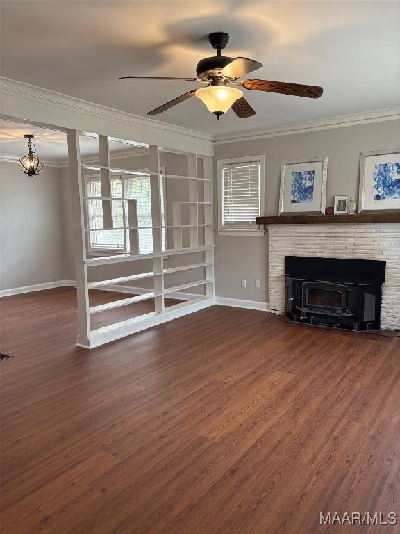 unfurnished living room featuring baseboards, dark wood-style floors, ceiling fan, crown molding, and a fireplace