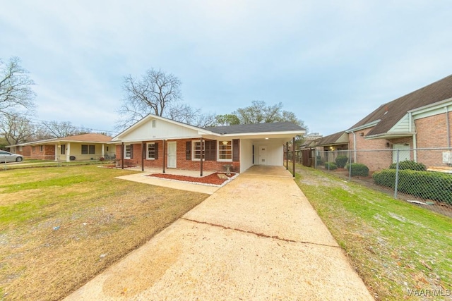 view of front facade featuring brick siding, concrete driveway, fence, an attached carport, and a front lawn