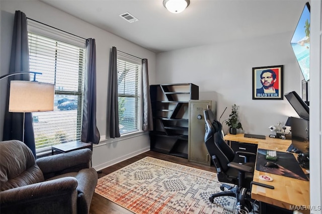 home office featuring baseboards, visible vents, and wood finished floors