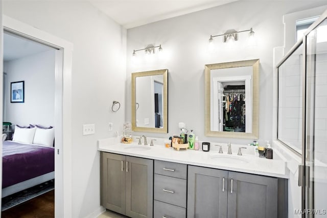 bathroom with a stall shower, a sink, ensuite bath, and double vanity