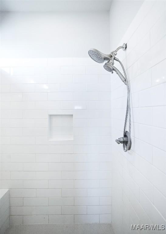 interior details with a tile shower