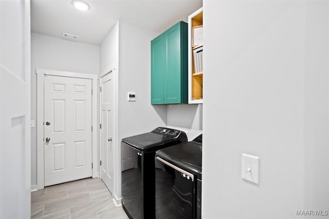 laundry room with cabinet space, visible vents, and washing machine and clothes dryer