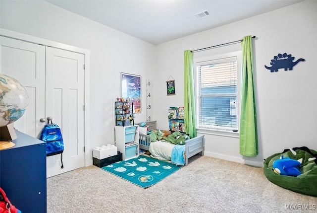 bedroom featuring carpet, visible vents, and a closet