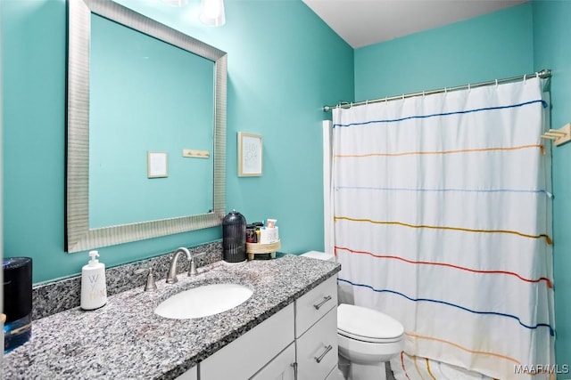 bathroom with toilet, a shower with shower curtain, and vanity