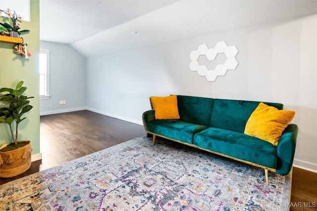 living area with lofted ceiling, wood finished floors, and baseboards