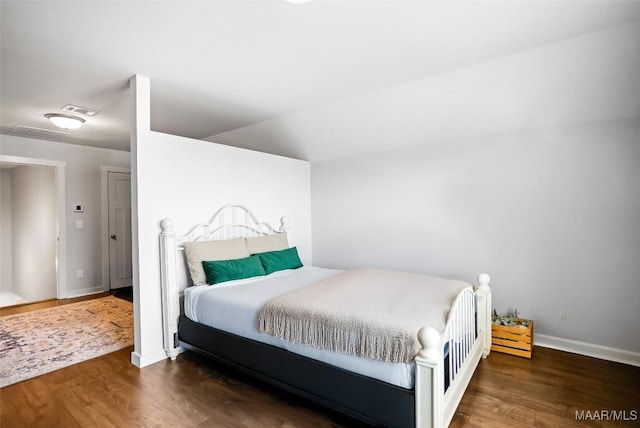 bedroom featuring baseboards, visible vents, and dark wood-type flooring